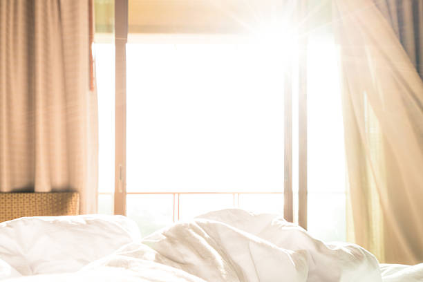 Morning sunlight streaming through a calm bedroom window