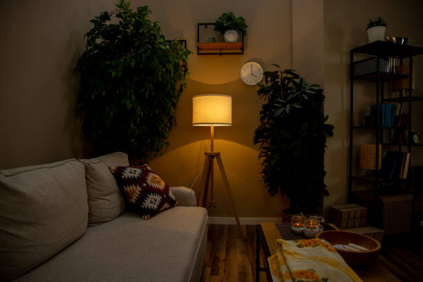 Warm amber lamp light glowing in a dim living room